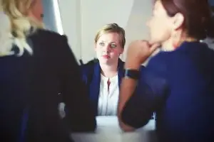 A picture of three business women in a deep discussion, representing a face to face personal advisory board.