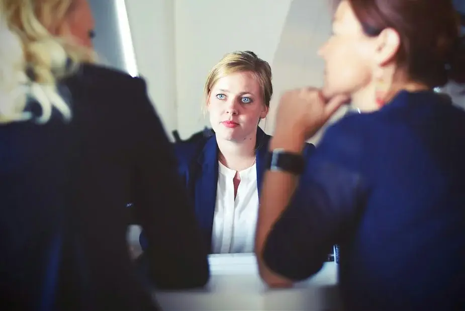 A picture of three business women in a deep discussion, representing a face to face personal advisory board.