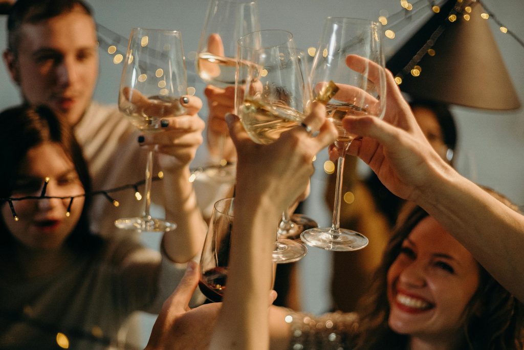 A photo of a group of people raising their glasses in celebration