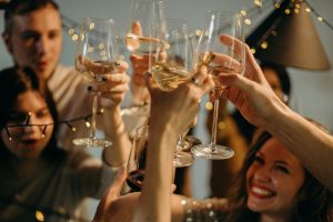 A photo of a group of people raising their glasses in celebration